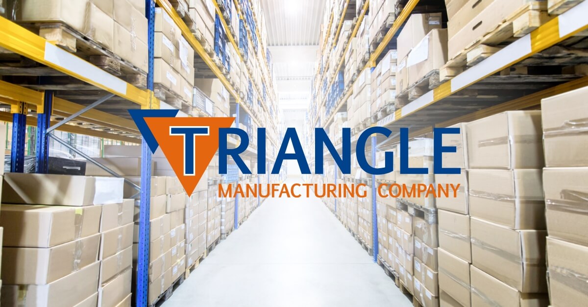 View of Triangle Manufacturing's boxed inventory on pallets and metal racks with company logo overlay.